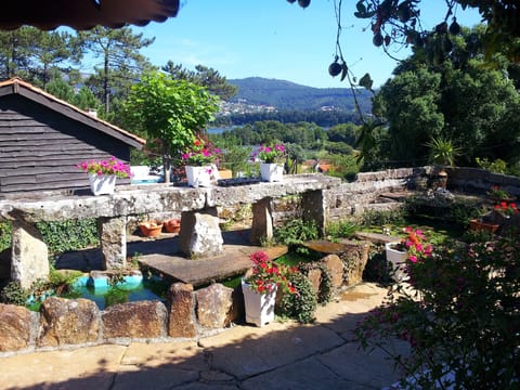 view from covered terrace over fish pond towards the estuary and Portugal
