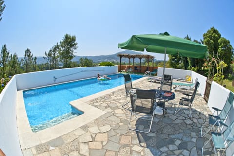 Large pool with a view, with plenty of sunbeds and shade.