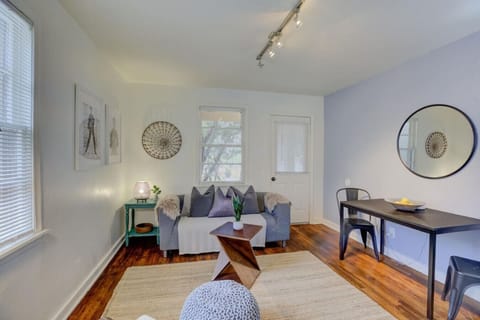Bright living room with a comfy sofa and a cute dining spot for two.