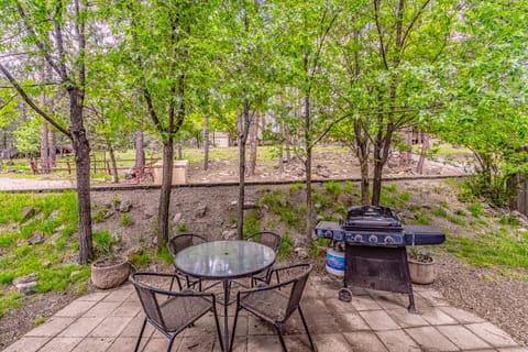 Relax on the front patio — perfect for morning coffee or dining al fresco beneath the pines.