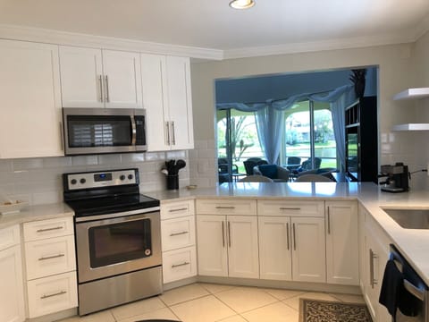 Kitchen view of living room, lanai & lake view