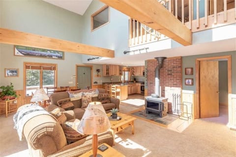 Open concept living room, dining area and kitchen with woodstove.