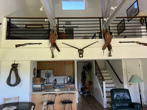 Larger view of the loft and kitchen. Rifles are replicas.