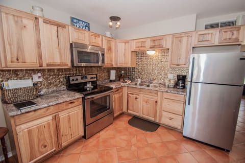 Full size kitchen including, dishes, pots and pans.