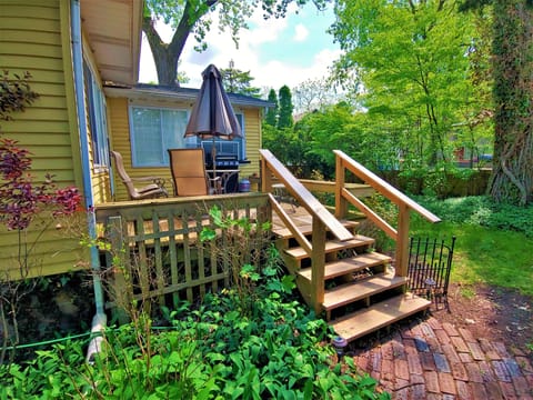 Back deck with grill and a small backyard space.