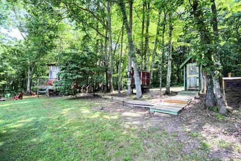 Outdoor shower and outhouse are adjacent to the cabin.