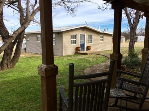 Back of the main house and front porch of the guest suite. 