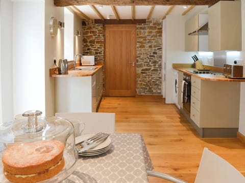 Charming dining area and adjacent kitchen | The Oak Stall - Higher Blagrove Farm Cottages, East Worlington, near South Molton