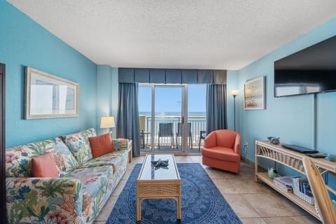 Relax in the comfort of a large well-appointed living room with an ocean view.