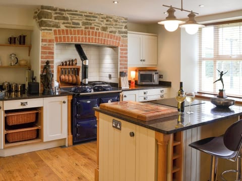 Farmhouse style kitchen area with oil-fired range | Cranford House - Cranford and The Coach House Cottages, Cranford, near Clovelly
