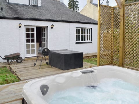 Rear garden area with hot tub and patio | Burnbrae Cottage, Bridgend of Lintrathen, near Forfar