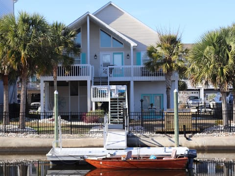 Waterside view of 10 Leland with private dock and fenced yard.