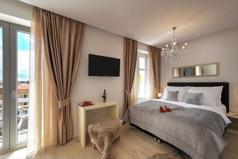 Room with queen size bed and balcony