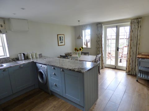 The kitchen and dining area with feature antique table. French doors to rear.