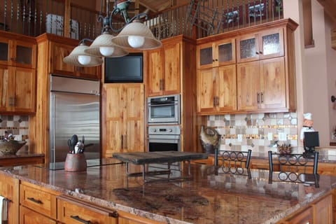 Gourmet kitchen with stainless steel appliances, and center island.