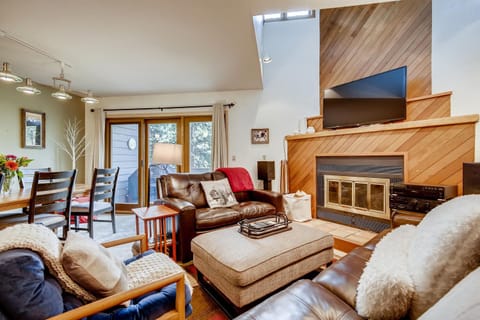Living area with wood burning fireplace and access to west facing deck