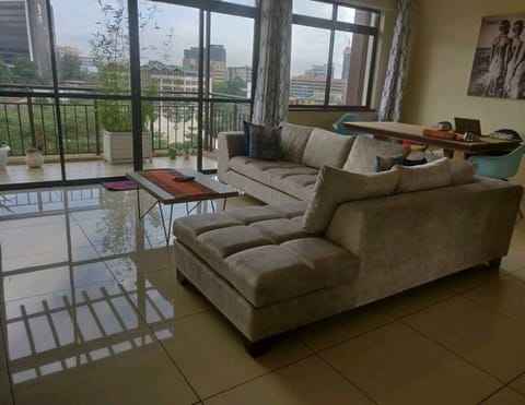 Modern open plan concept living room with large sofa & balcony view
