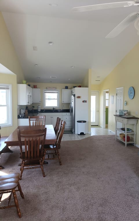 Dining and kitchen area with bathroom  and front deck door on the right.