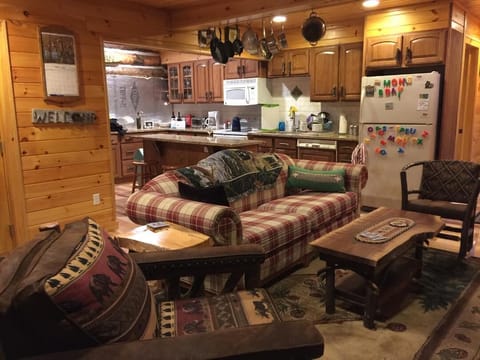 family gathering area with TV /kitchen with countertops for prepping meals.