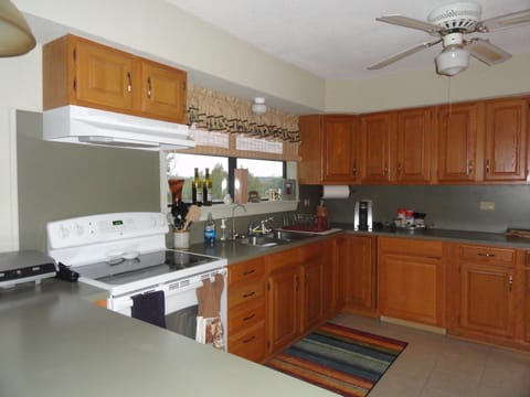 Full size kitchen with pots, pans, cooking utensils,dishes, etc.