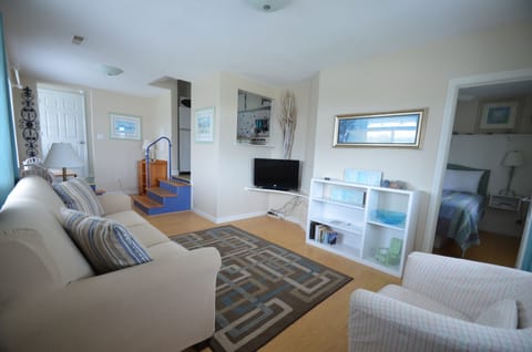 Step in off the balcony to the living space.  Bedroom to the right, kitchen straight ahead, bathroom far left.