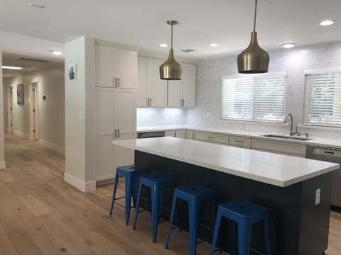 The stylish kitchen is light and bright, with gorgeous quartz countertops.