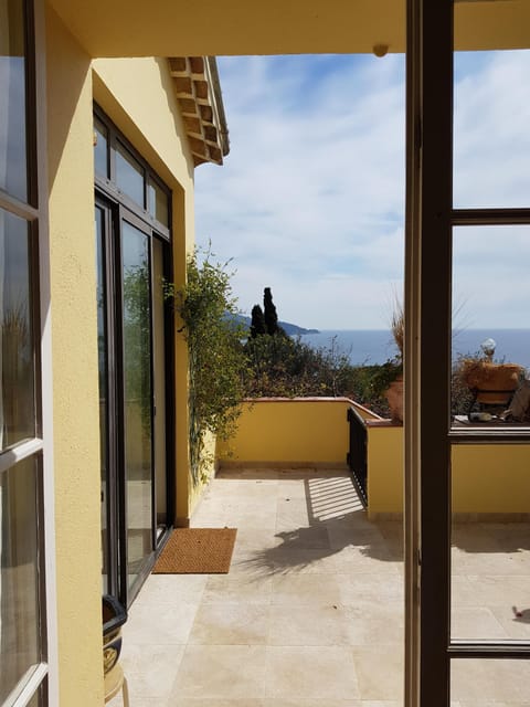 french doors open onto front upper patio from living room