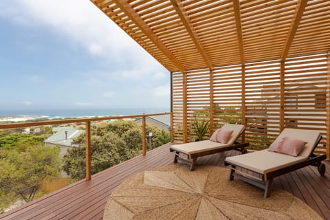 Relax on the deck and watch the surfers down at the beach.