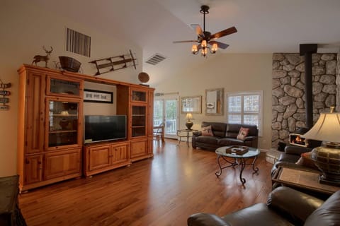 Rustic/Elegant Living Room with wood floors, leather furniture and media Cabinet
