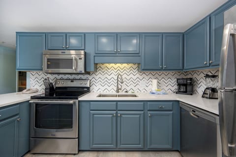 Inviting kitchen featuring stylish cabinetry, stainless appliances, and coffee corner with Keurig and traditional pot