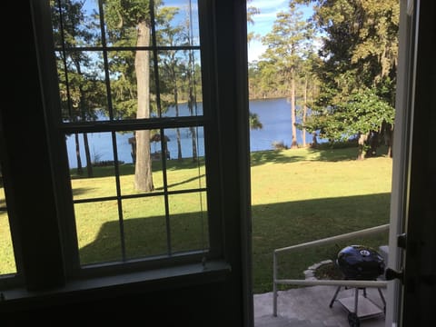 Open door on the back.  Looking at the charcoal grill and lake.