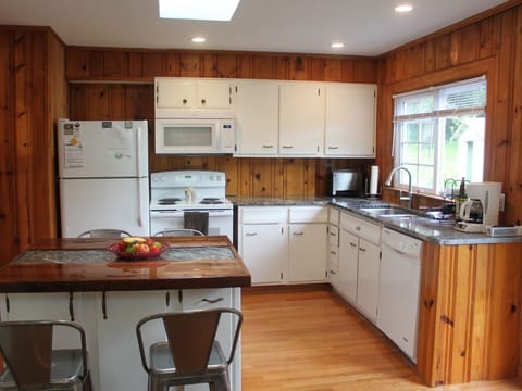kitchen w/ rolling island seats 4, can be moved for large gatherings