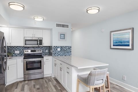 Fully equipped kitchen with brand new appliances and large island with breakfast bar style seating