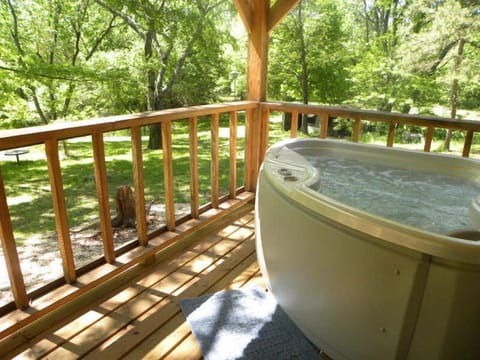 Outdoor Hot Tub to enjoy with the tree uplighting for extra ambiance