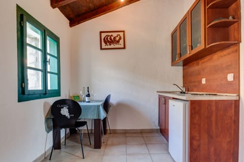 There is a small kitchenette equipped with utensils and dishes. 
