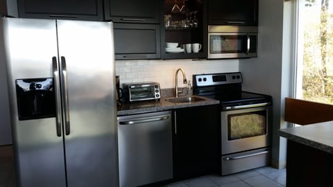 Stainless steel, solid surface, subway tile backsplash and a dream to cook in!