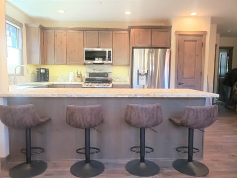 10 feet of leathered granite and adjustable bar stools.