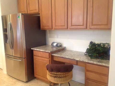 Desk area in kitchen area with WIFI and phone.