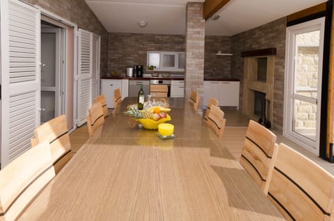 Big outside dinning table and kitchen with barbecue area