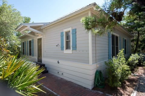 Outdoor shower and hooks to hang towels.