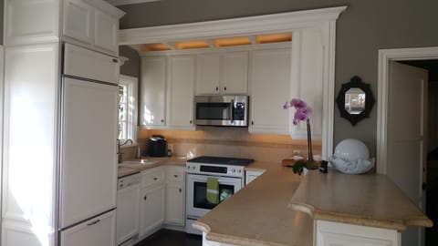 KITCHEN FULLY STOCKED W/ QUALITY CONDIMENTS, SPICES, COOKWARE, GLASSES, ETC.