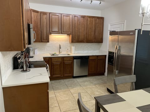 Fully equipped kitchen with Quartz countertops, marble backsplash, Keurig elite