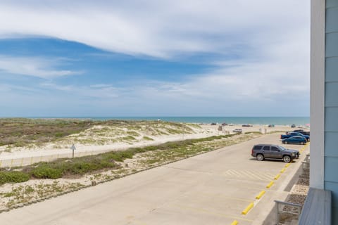 Beachfront property offers direct access to pristine sandy shores with convenient parking and stunning coastal views.