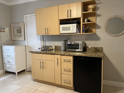 Kitchen area: toaster oven, microwave, under the counter refrigerator, cook top