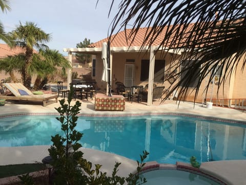 Relax in private back yard with pool and spa. 