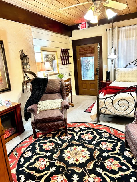 Electric fireplace on left, recliner, desk area and private entrance from porch