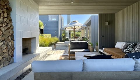 The house wraps around a sheltered courtyard terminating in a magic outdoor room