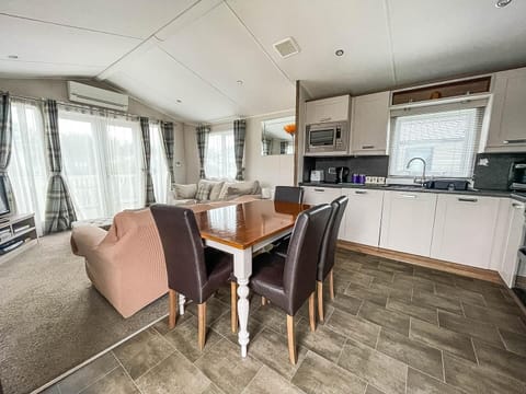 The dining table is perfect for everything from family breakfasts to evening board games, creating an inviting hub for socialising and dining.