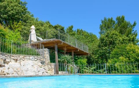 The beautiful private heated pool with sun terrace and dining terraces above