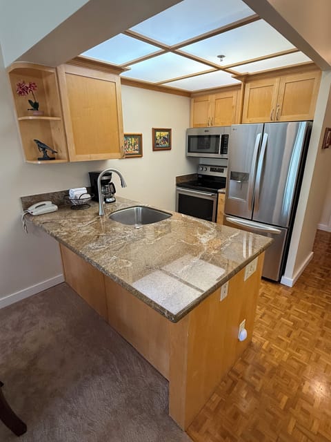 The kitchen features pots & pans, glasses, dishes, spices & coffee filters,